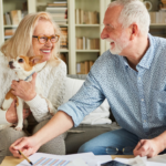 April 25 Events Page Image - Vista Pointe at Mira Loma Elderly man and woman smiling and holding small dog